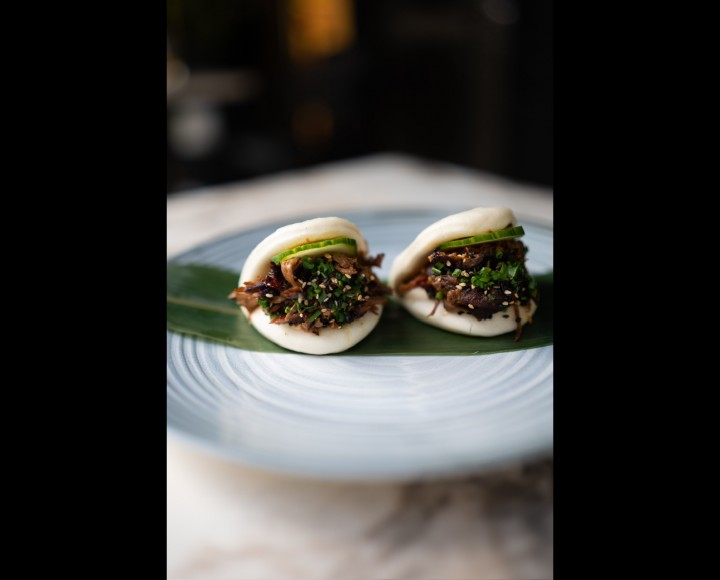 <h3 class='prettyPhoto-title'>Frayed Gua Bao Brisket </h3><br/>2 Bao bread stuffed with shredded brisket, candied onions, grated carrots, red and white cabbage, Tomahawk sauce